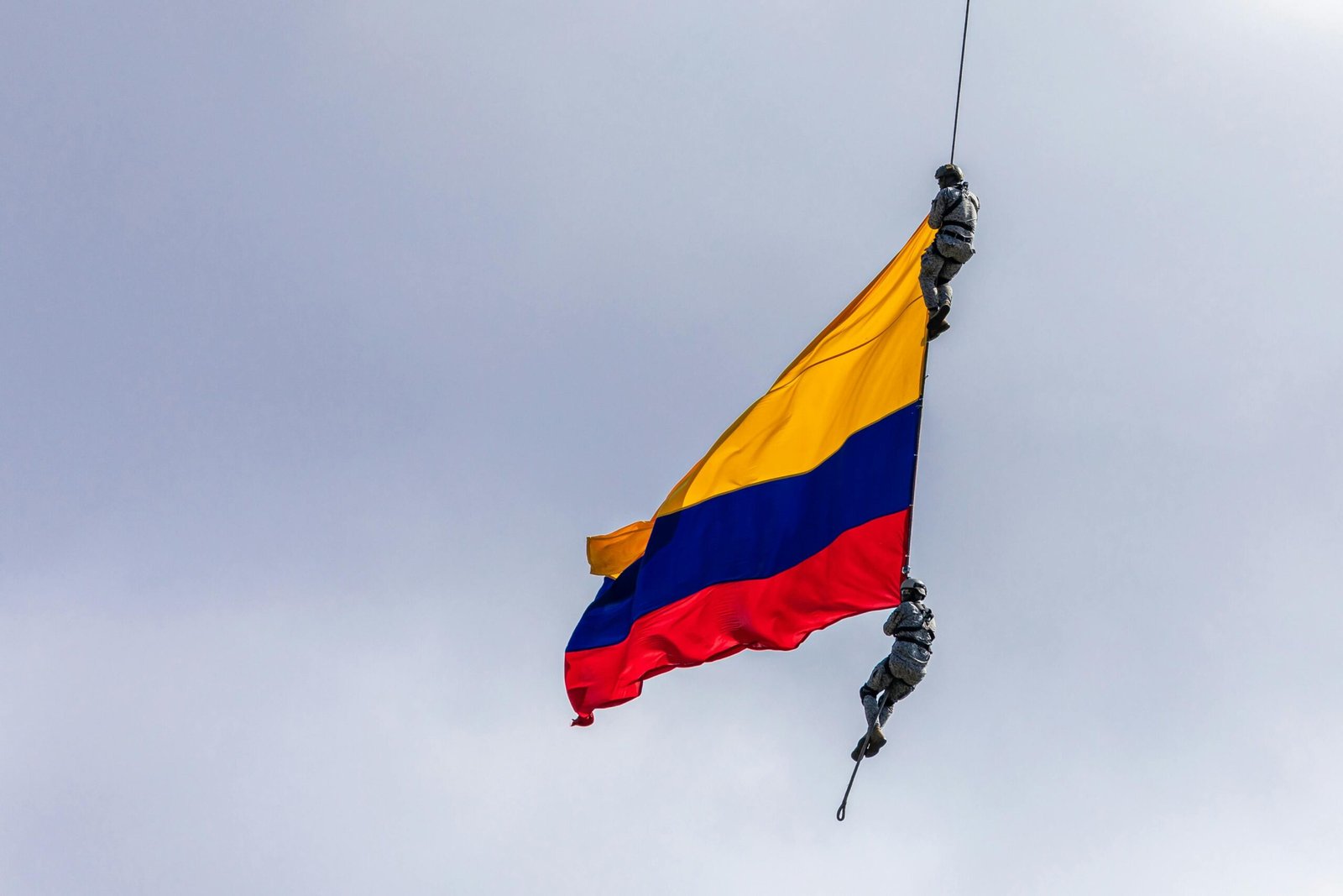 team-2 Colombian flag with two soldiers performing an aerial stunt in Medellín.
